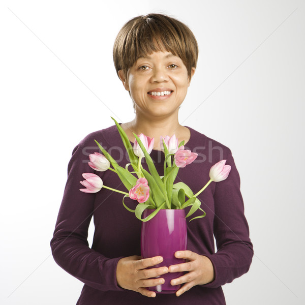 Woman holding flowers. Stock photo © iofoto