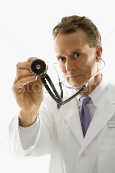Doctor holding stethoscope. Stock photo © iofoto