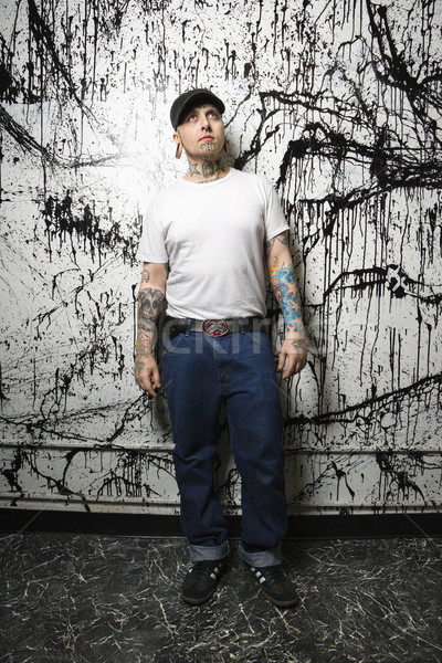 Tattooed and pierced man. Stock photo © iofoto