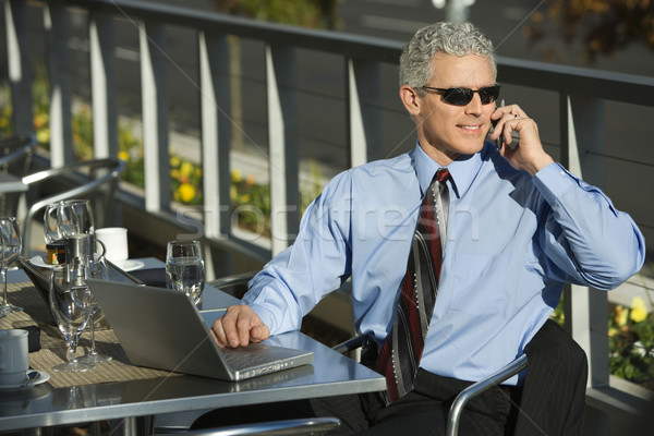 Stock photo: Businessman on cellphone.