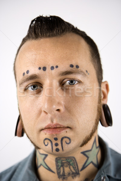 Man with tattoos and piercings. Stock photo © iofoto