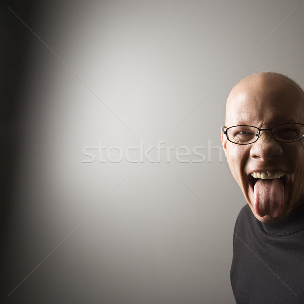 Man sticking out tongue. Stock photo © iofoto