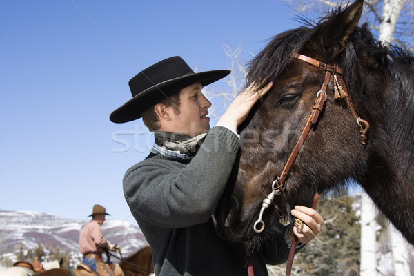 Attractive Young Man Petting Horse Stock photo © iofoto