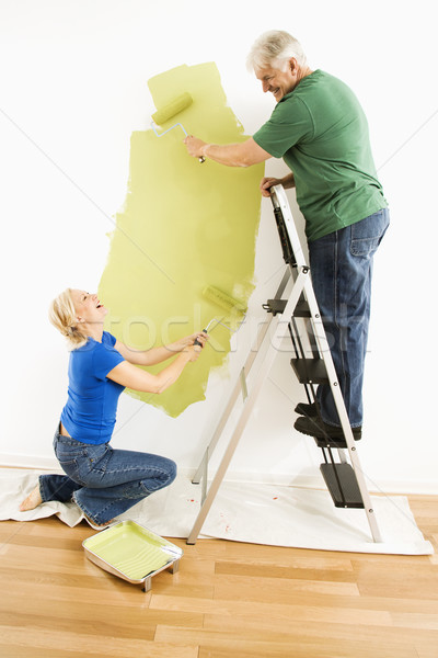 Man and woman painting wall. Stock photo © iofoto