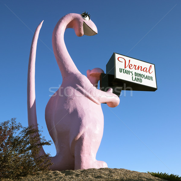 Pink dinosaur holding sign. Stock photo © iofoto