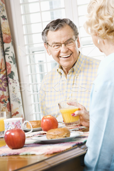 Mature couple eating breakfast. Stock photo © iofoto