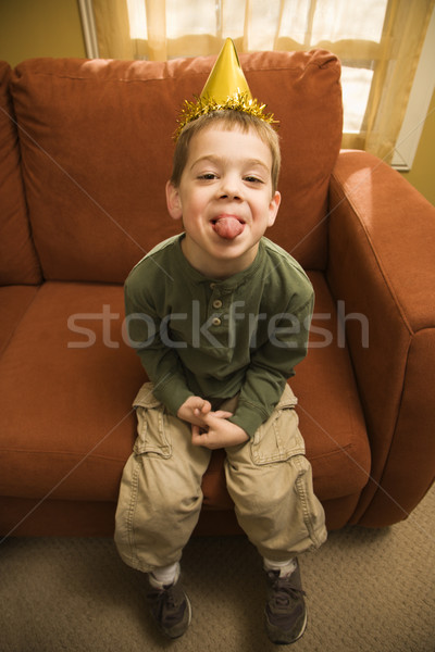 Boy sticking out tongue. Stock photo © iofoto