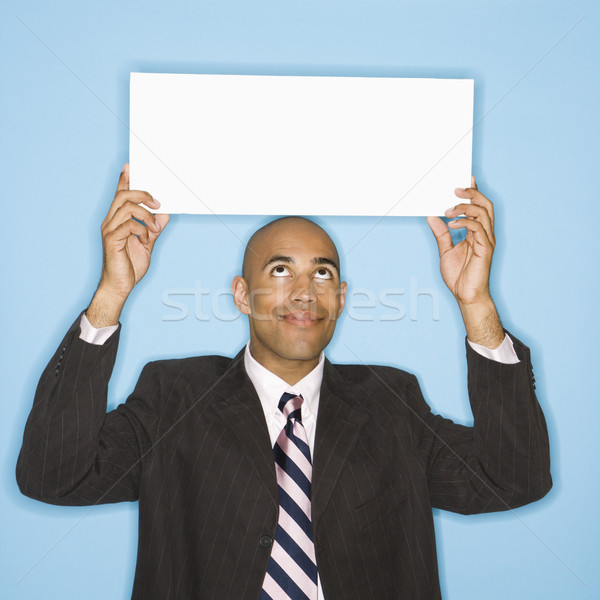 Businessman holding blank sign. Stock photo © iofoto