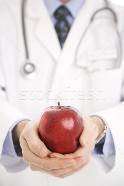 Doctor holding apple. Stock photo © iofoto