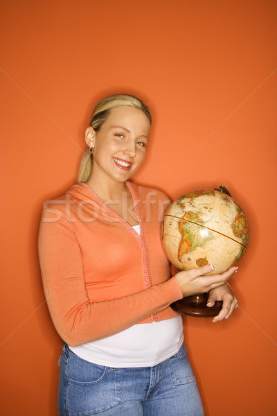 Stock photo: Teen girl holding globe.