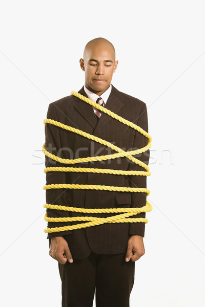 Businessman tied in rope. Stock photo © iofoto