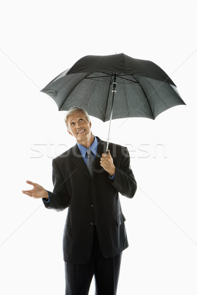 Om umbrelă caucazian varsta mijlocie om de afaceri Imagine de stoc © iofoto