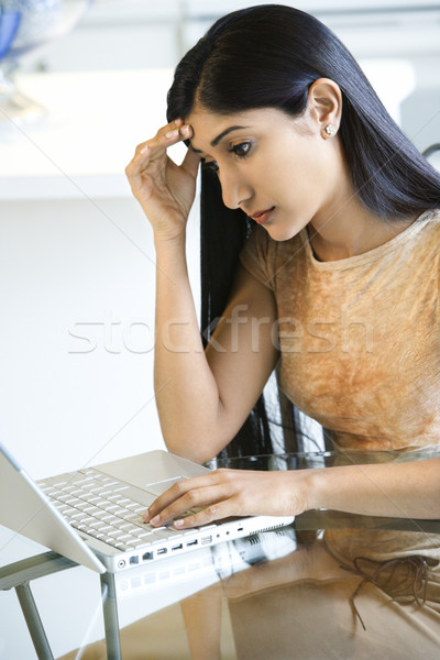 Concerened Young Woman Using Laptop Stock photo © iofoto
