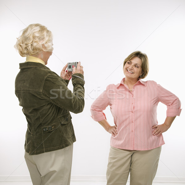 Stock photo: Women using digital camera.