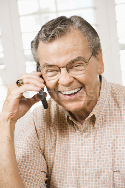 Mature man on cellphone. Stock photo © iofoto