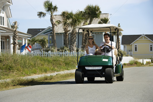 Couple in golf cart. Stock photo © iofoto