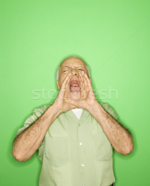 Man with hands to mouth yelling. Stock photo © iofoto