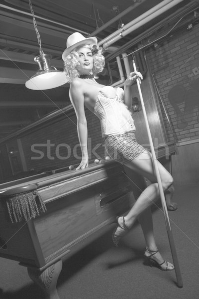 Retro woman in pool hall. Stock photo © iofoto