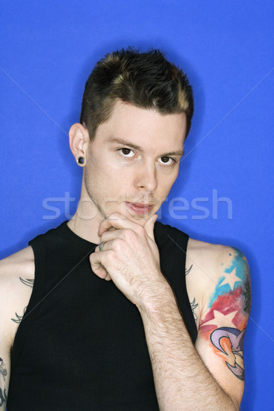 Man with pierced ear and tattoo. Stock photo © iofoto