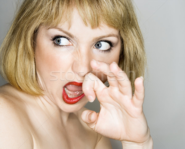 Woman looking disgusted. Stock photo © iofoto