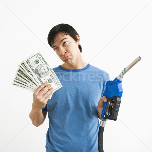 Man with money and gas nozzle. Stock photo © iofoto