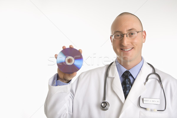 Stock photo: Doctor holding compact disc.