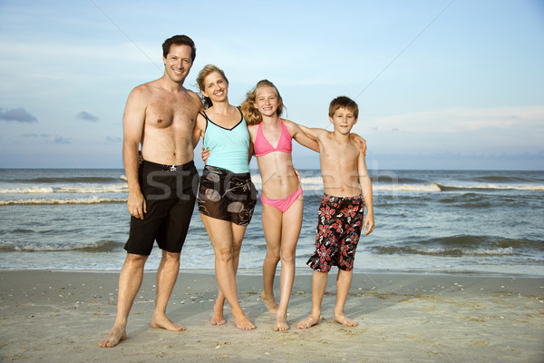 Stock photo: Happy smiling family on beach.