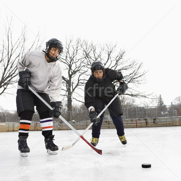 Boys playing ice hockey. Stock photo © iofoto