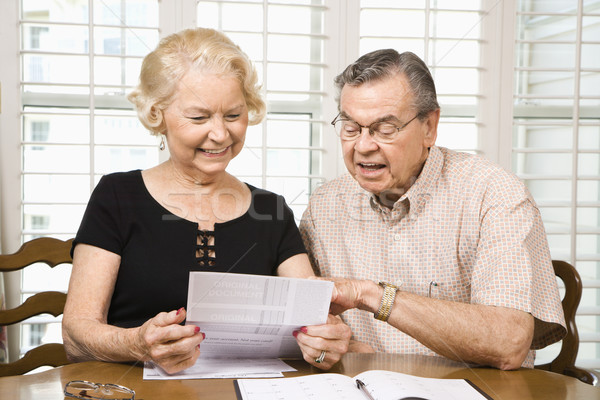 Mature couple with bills. Stock photo © iofoto