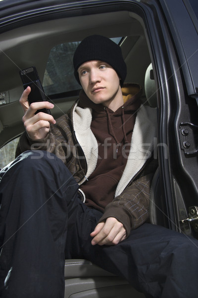 Teen holding cellphone. Stock photo © iofoto