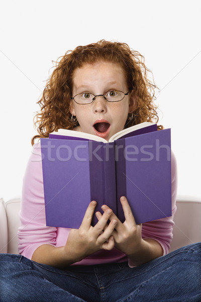 Dziewczyna czytania patrząc zdziwiony kobiet Zdjęcia stock © iofoto