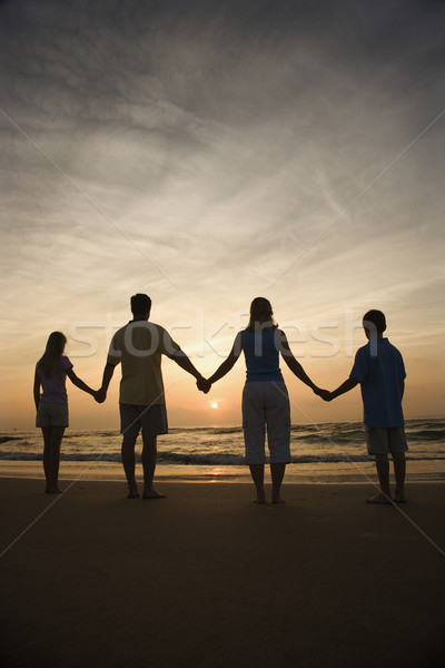 Foto stock: Familia · tomados · de · las · manos · playa · silueta · viendo · puesta · de · sol