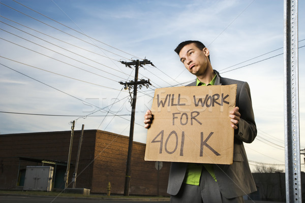 Young Businessman Holding 401k Sign Stock photo © iofoto