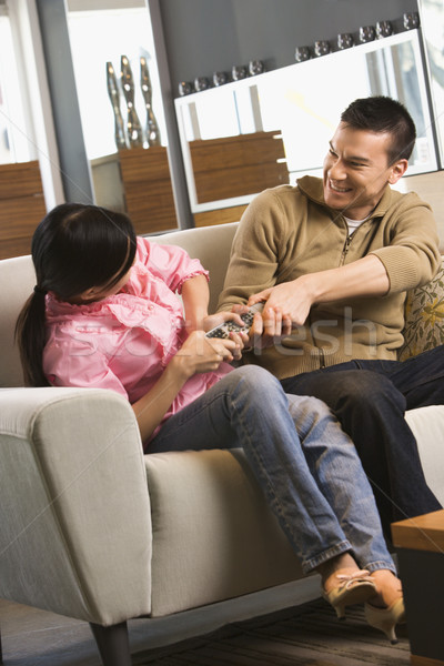 Couple fighting over remote. Stock photo © iofoto