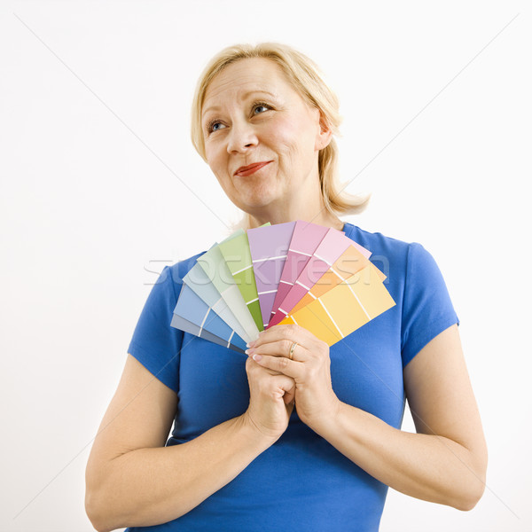 Wishful woman with paint swatches. Stock photo © iofoto