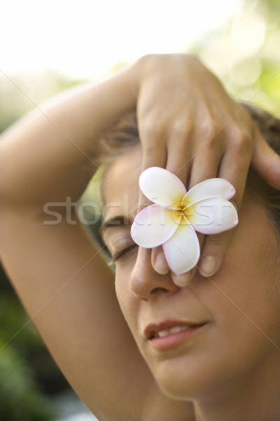 Woman holding plumeria flower. Stock photo © iofoto
