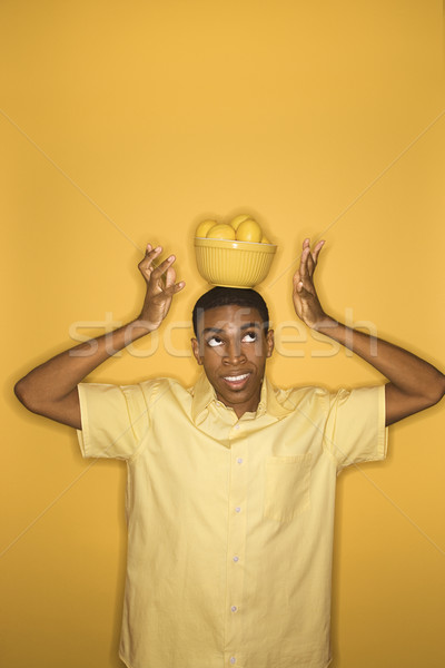 Man balancing lemons. Stock photo © iofoto