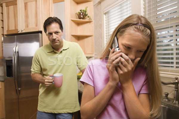 Father watching Daughter on phone Stock photo © iofoto