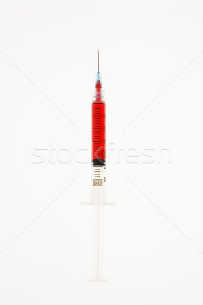 Stock photo: Needle with red liquid.