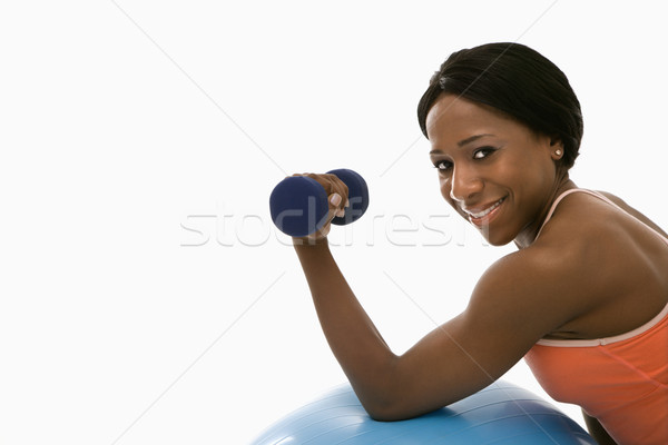 Stock photo: Woman lifting dumbbell.