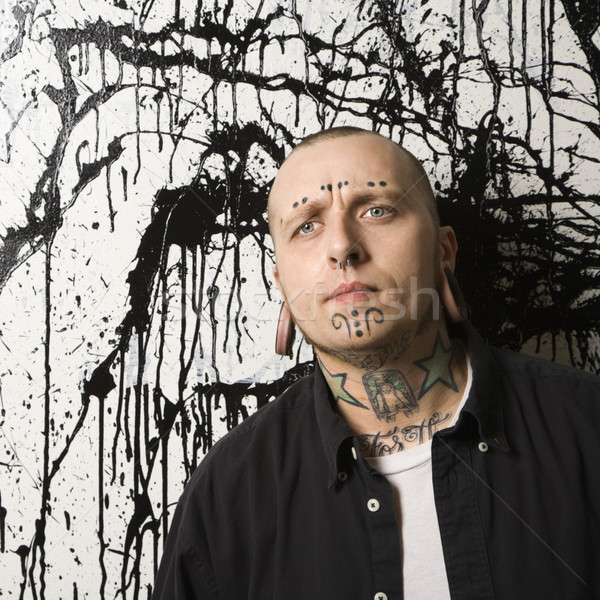 Tattooed and pierced man. Stock photo © iofoto