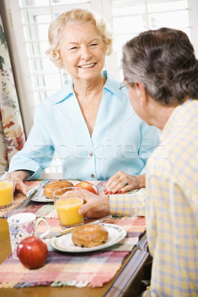Mature couple eating breakfast. Stock photo © iofoto