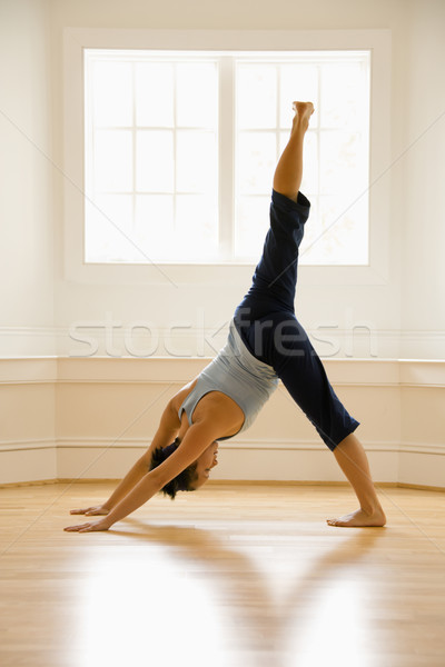 Woman in yoga pose Stock photo © iofoto