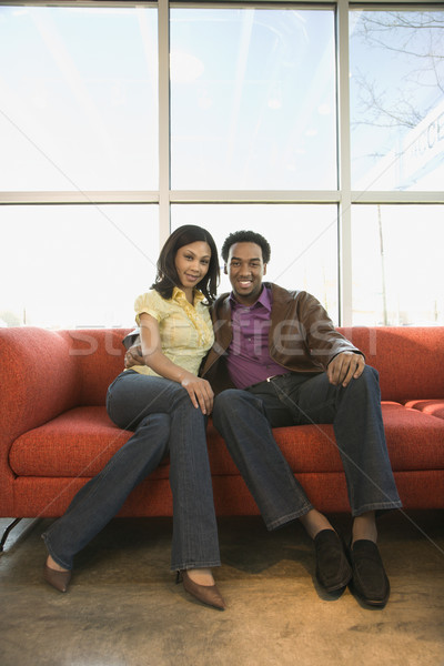 Couple sitting on couch. Stock photo © iofoto