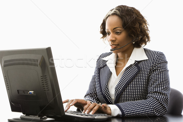 Femme d'affaires travail séance tapant ordinateur [[stock_photo]] © iofoto