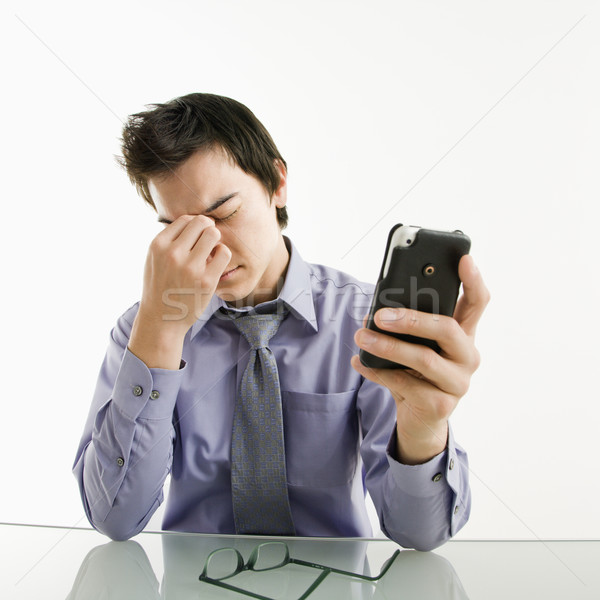 устал бизнесмен сотового телефона азиатских глазах КПК Сток-фото © iofoto