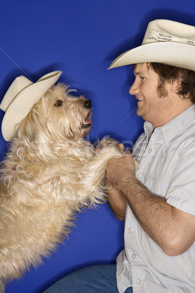 Dog and man in cowboy hats. Stock photo © iofoto