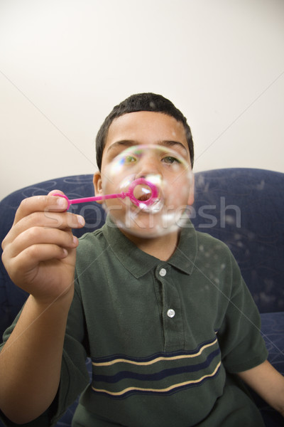 Boy blowing bubbles. Stock photo © iofoto
