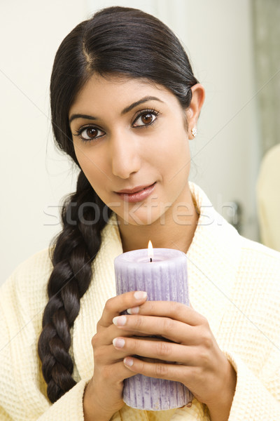 Young woman holding candle. Stock photo © iofoto
