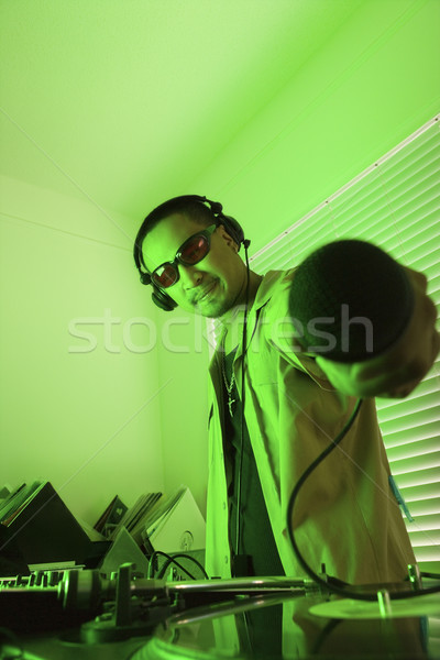 Male DJ holding microphone. Stock photo © iofoto